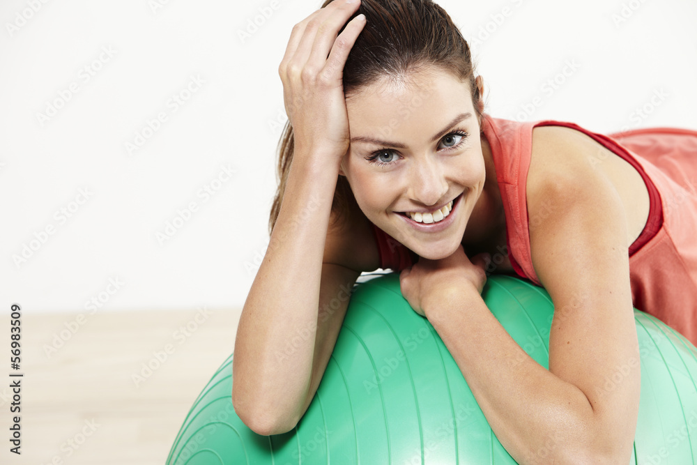 young woman relaxing on a pilates ball