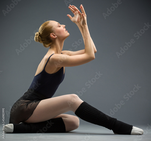 Dancing on the floor ballerina with hands up