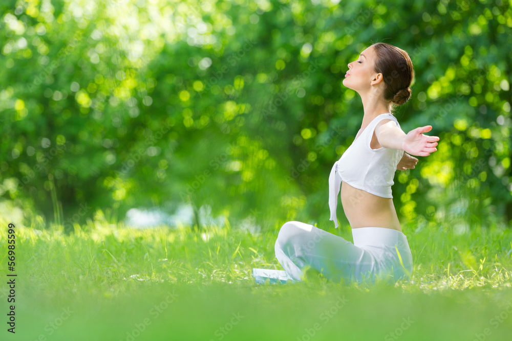 Profile of woman sitting in lotus position Profile of woman sitting in lotus position