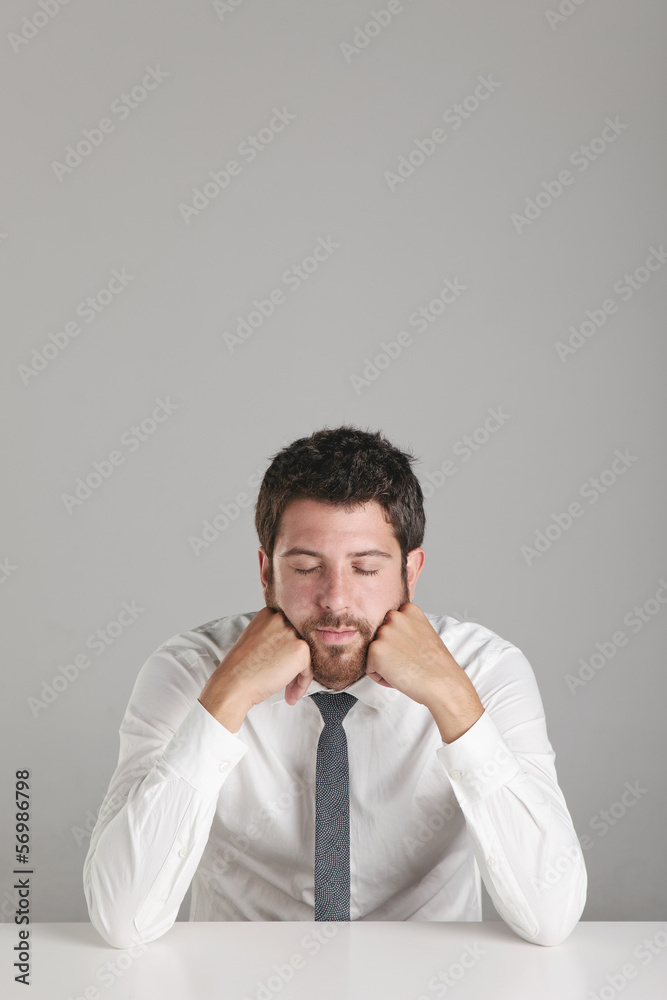 Portrait of a young businessman sleeping on desktop. Portrait of a young businessman sleeping on desktop.