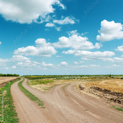 two dirty roads under blue cloudy sky