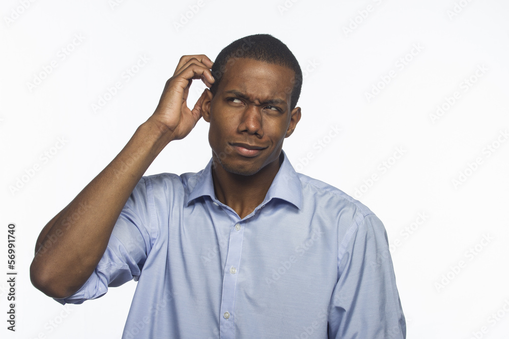 Young black man confused and scratching head, horizontal Stock Photo