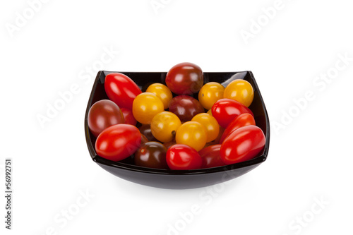 Cherry tomatoes in black plate isolated on white background