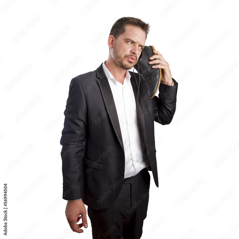 Business man talking to his shoe Business man talking to his shoe