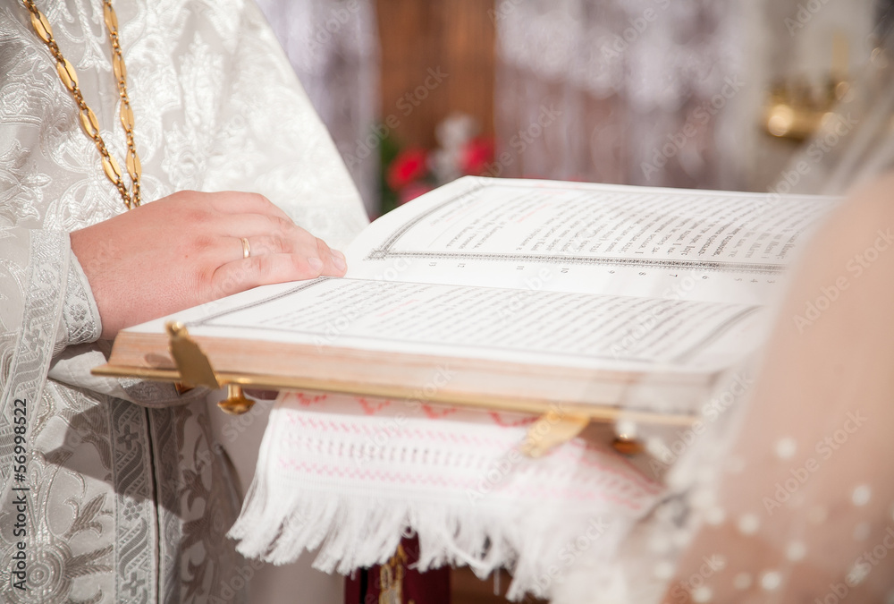 Priest giving Bible to bride during wedding ceremony Stock Photo ...