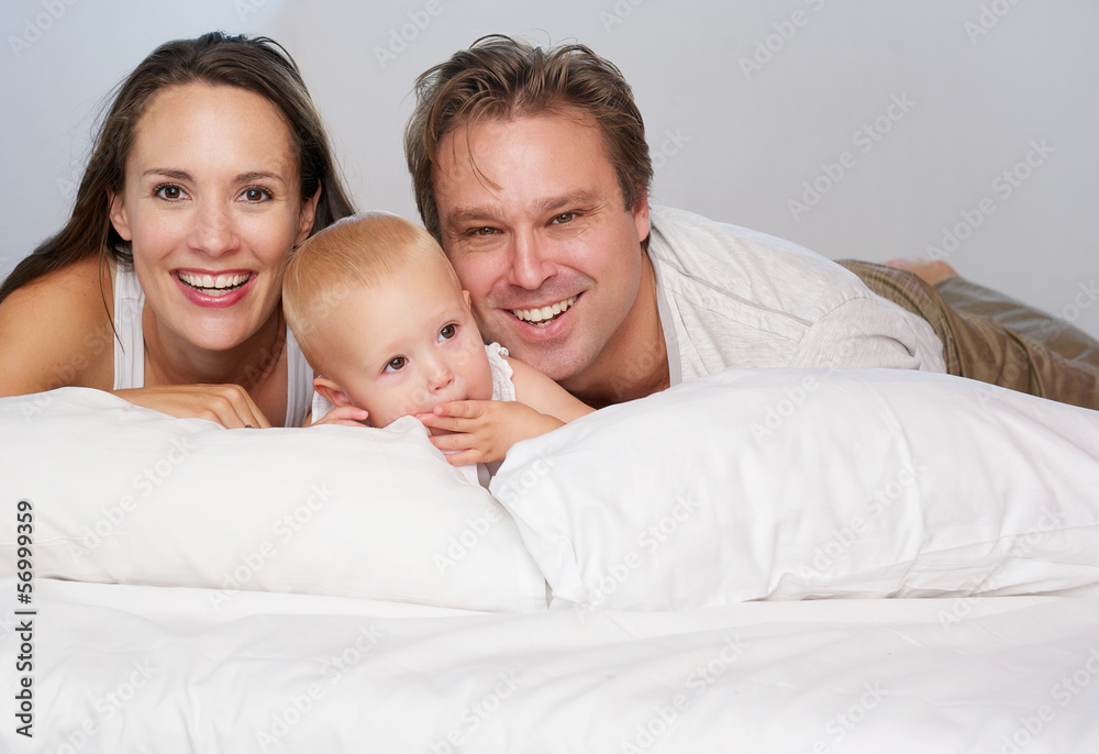 Happy loving family smiling with cute baby