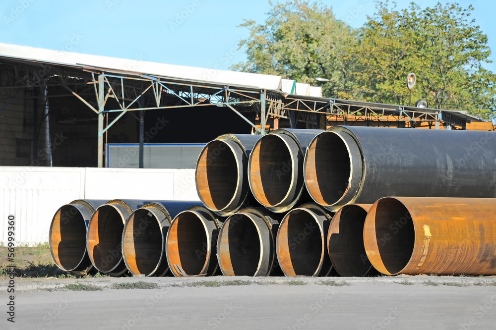 Rusty steel pipe with heat insulation on construction site