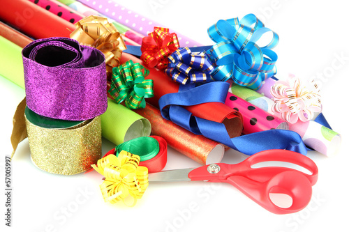 Rolls of Christmas wrapping paper with ribbons, bows isolated