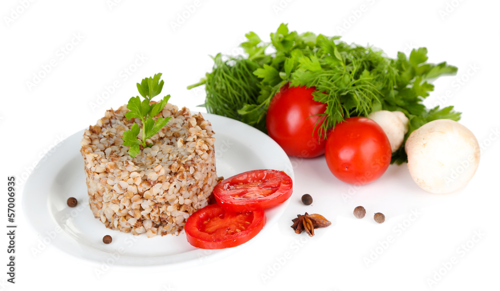 Buckwheat in plate and vegetables isolated on white Buckwheat in plate and vegetables isolated on white