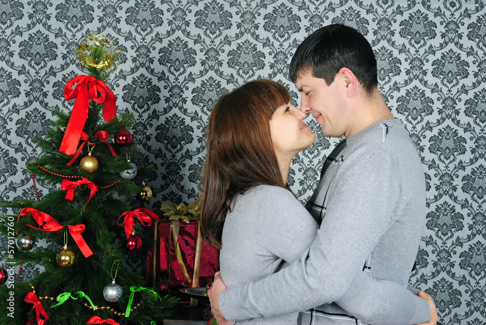 young couple in love near new year's fir tree