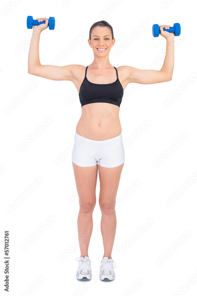 Happy fit woman working out with dumbbells Happy fit woman working out with dumbbells