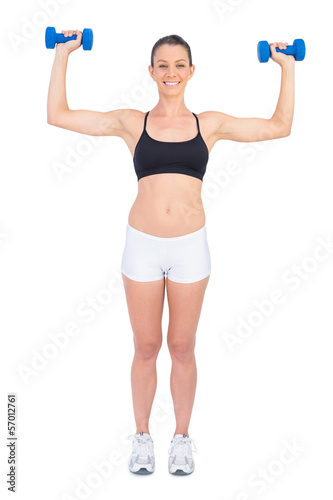 Happy fit woman working out with dumbbells
