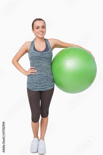 Cute young woman holding a fitness ball