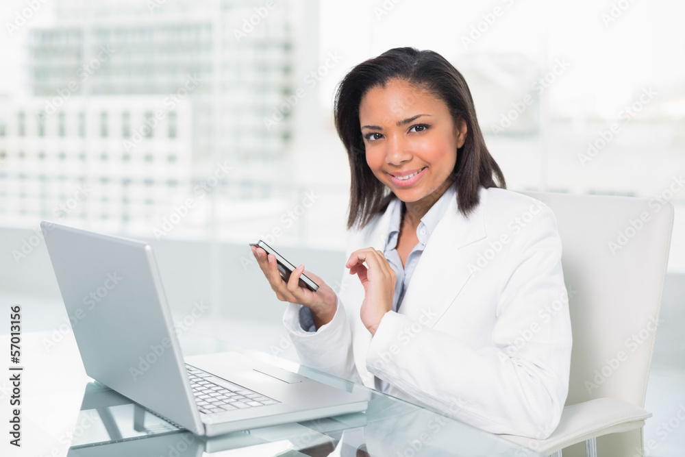 Natural young dark haired businesswoman using a mobile phone Natural young dark haired businesswoman using a mobile phone