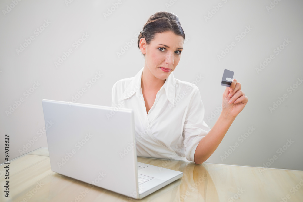Content pretty businesswoman shopping online using laptop Content pretty businesswoman shopping online using laptop
