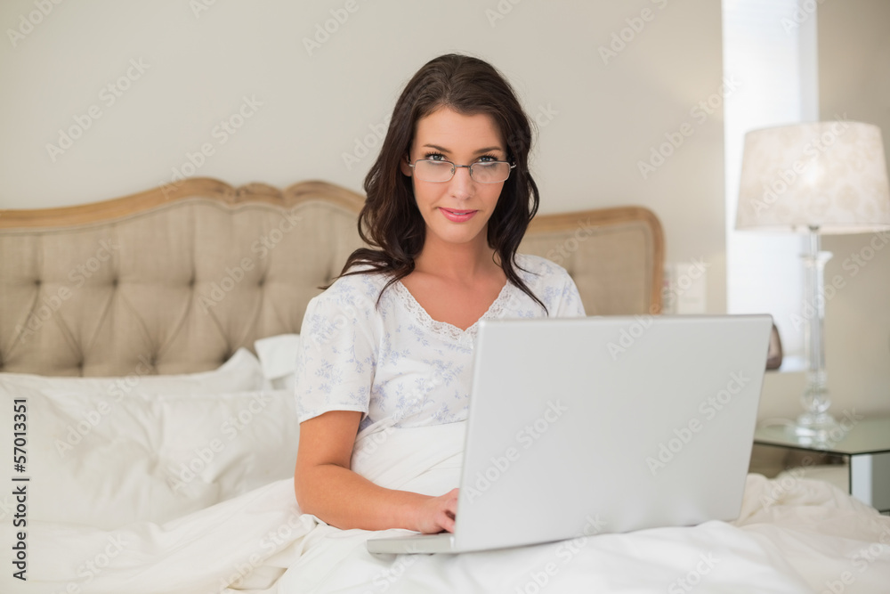 Stern pretty brown haired woman typing on a laptop Stern pretty brown haired woman typing on a laptop