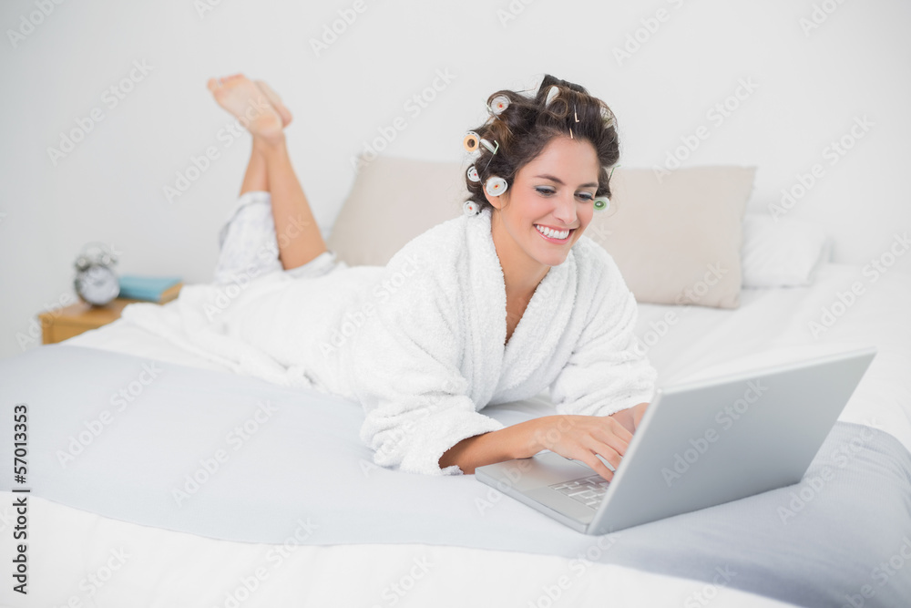 Cheerful natural brunette using laptop Cheerful natural brunette using laptop
