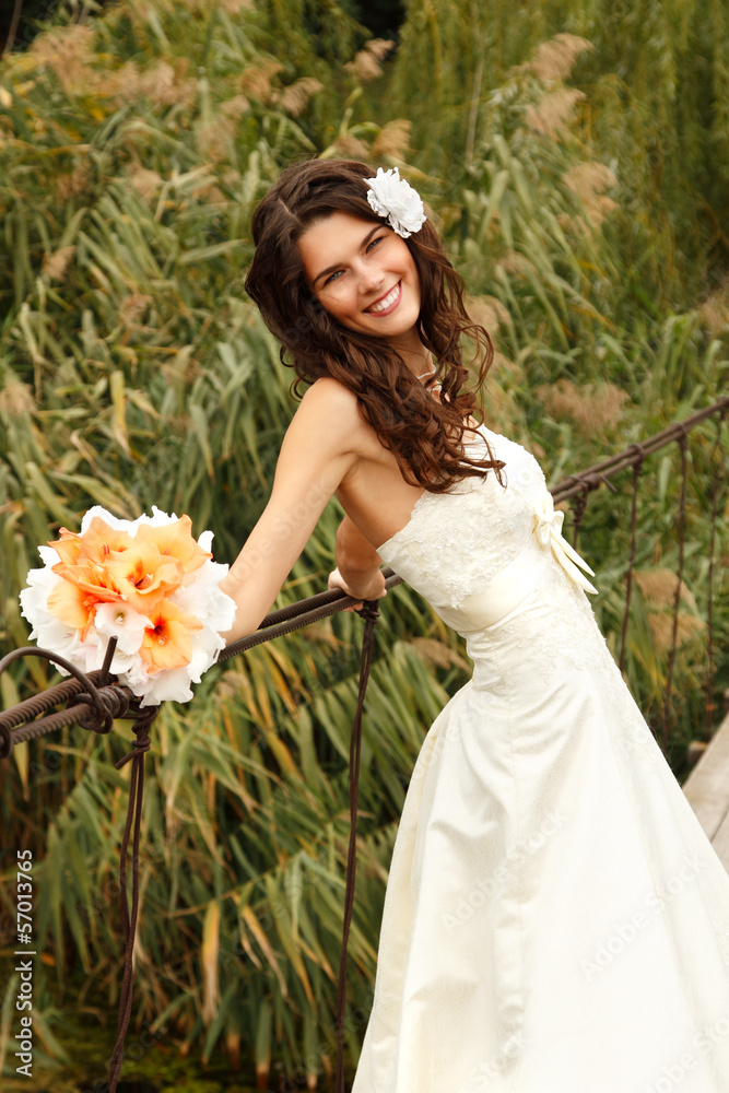 young beautiful woman bride's portrait on the bridge, summer out young beautiful woman bride's portrait on the bridge, summer out
