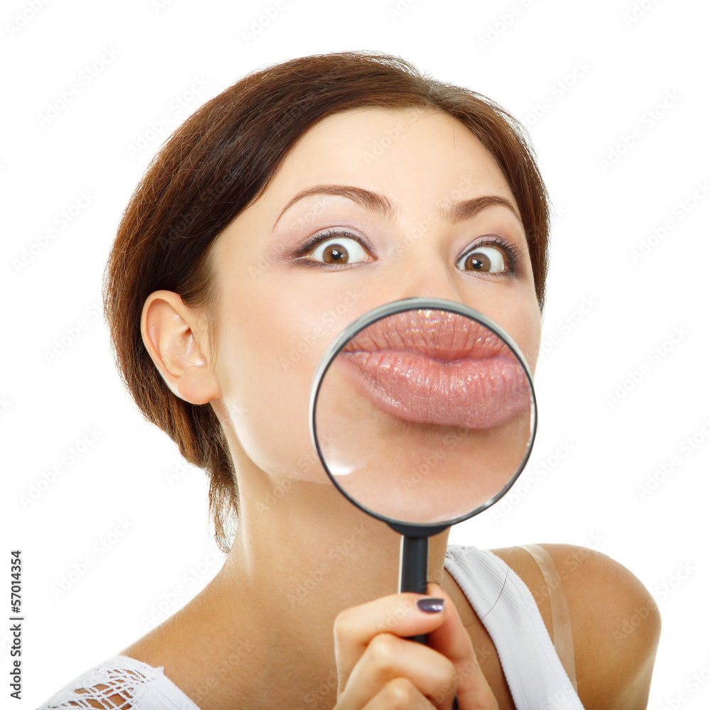 funny woman looking through a magnifying glass over white funny woman looking through a magnifying glass over white