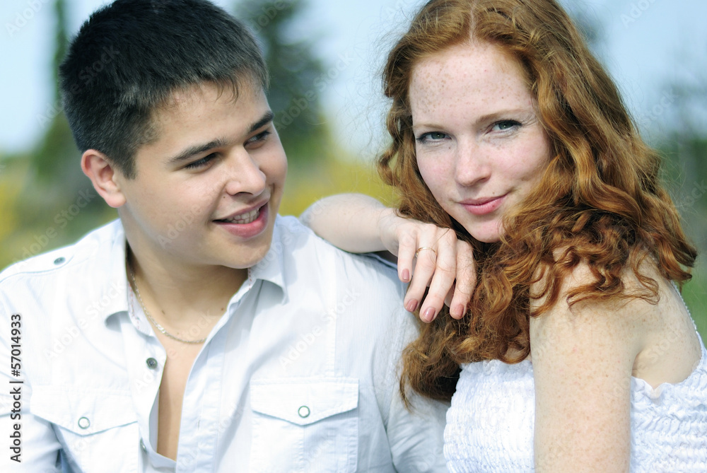 beautiful young couple in love on a green glade beautiful young couple in love on a green glade