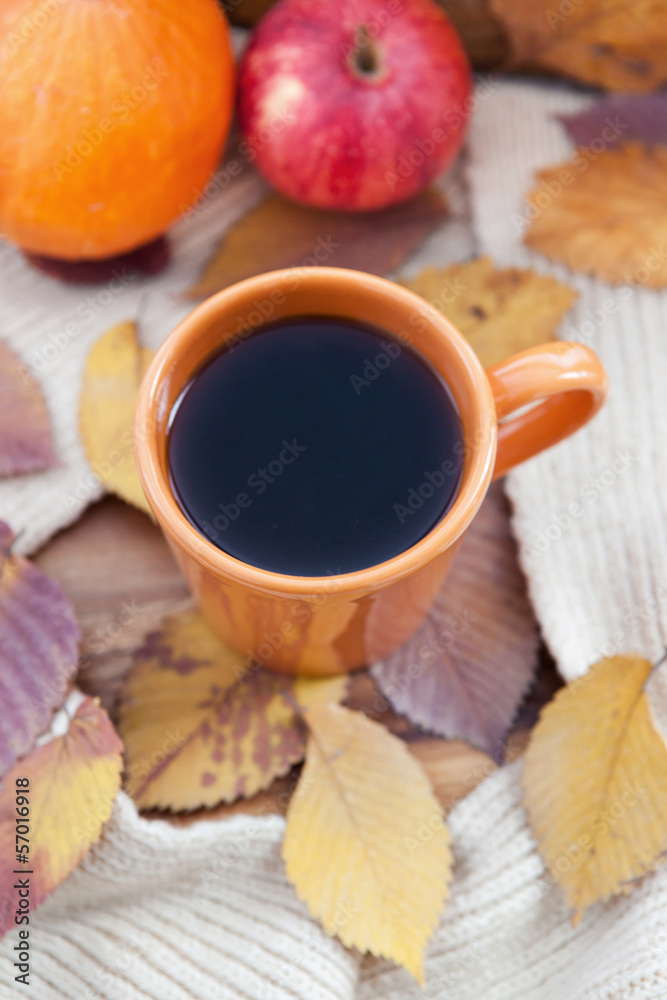 Orange coffee cup on the autumn fall leaves Orange coffee cup on the autumn fall leaves