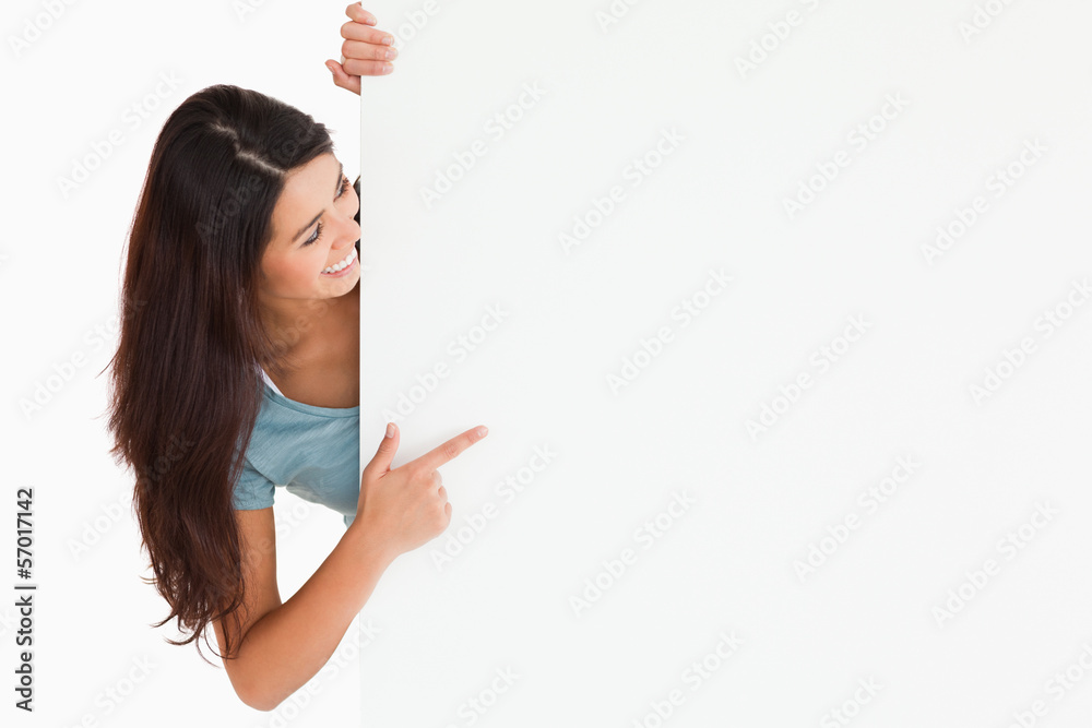 Gorgeous woman pointing at a board Gorgeous woman pointing at a board