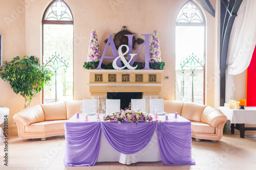 Bride and groom's table decorated with flowers photo