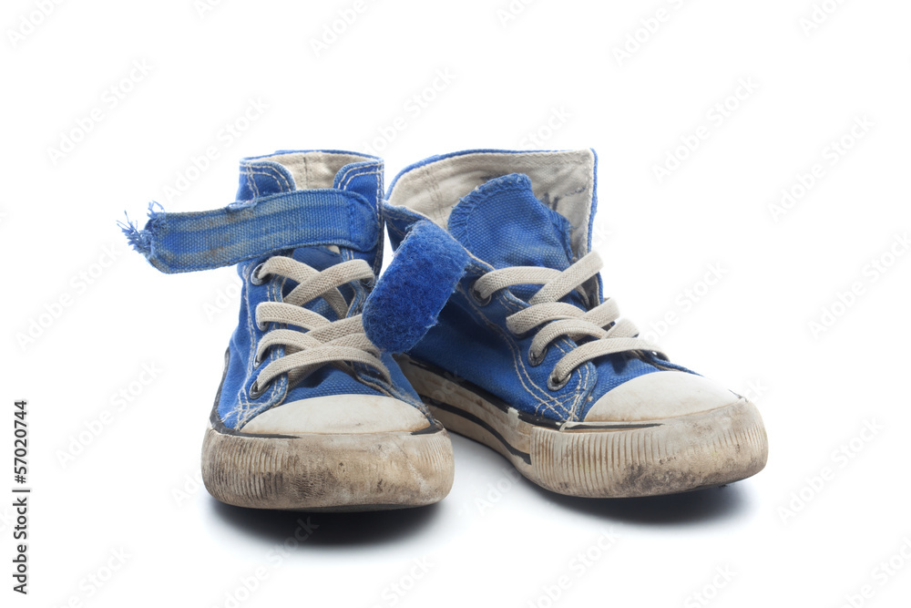Pair of dirty, worn out blue children sneakers Pair of dirty, worn out blue children sneakers