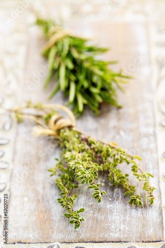 Rosemary and thyme herbs on the wooden table