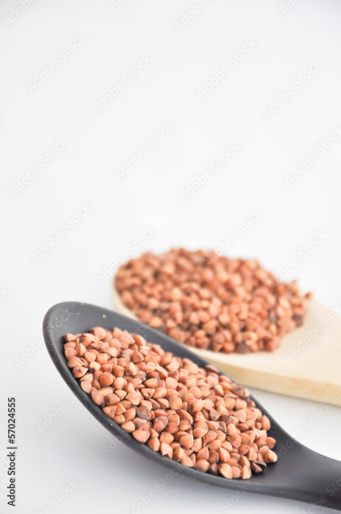 Fototapeta premium buckwheat in a bowl with spoon