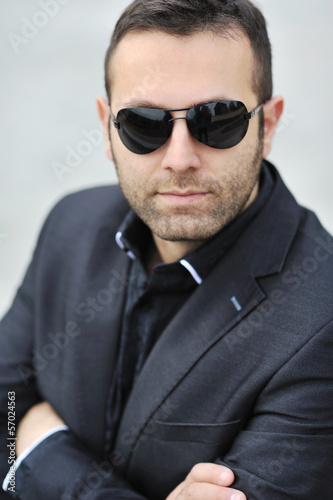 Closeup portrait of handsome man's face wearing sunglasses - out © paultarasenko
