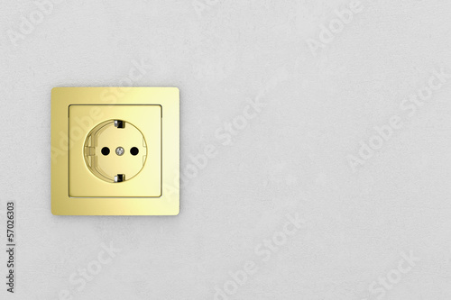 Golden power plug on white wall frontal