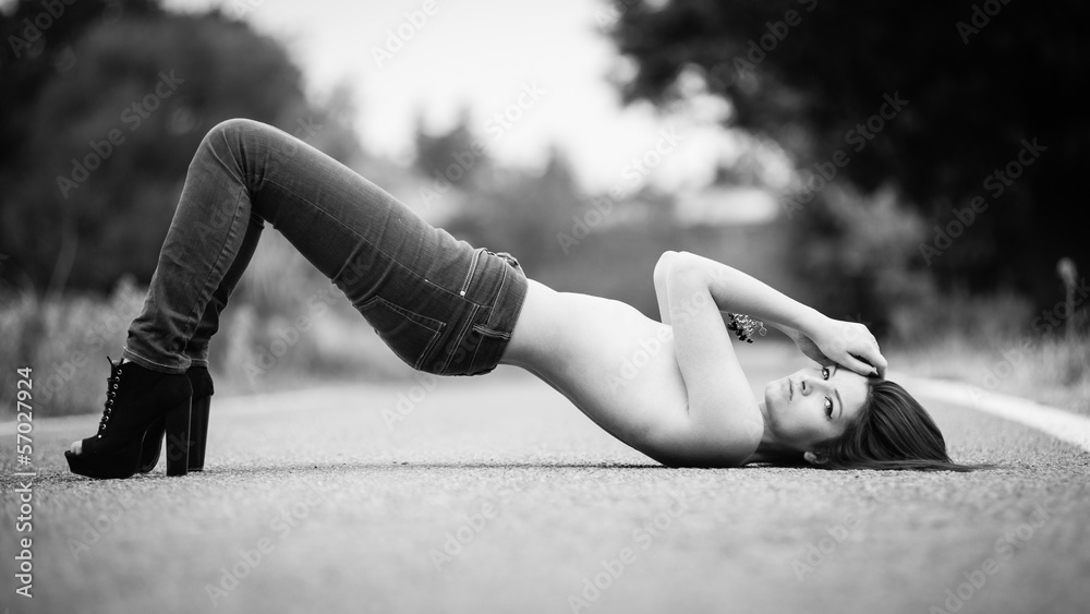 Fototapeta premium Young woman portrait on the road. Black and white image.