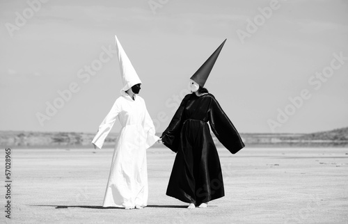 Two people in black cloak and white cloak talking. Artwork photo