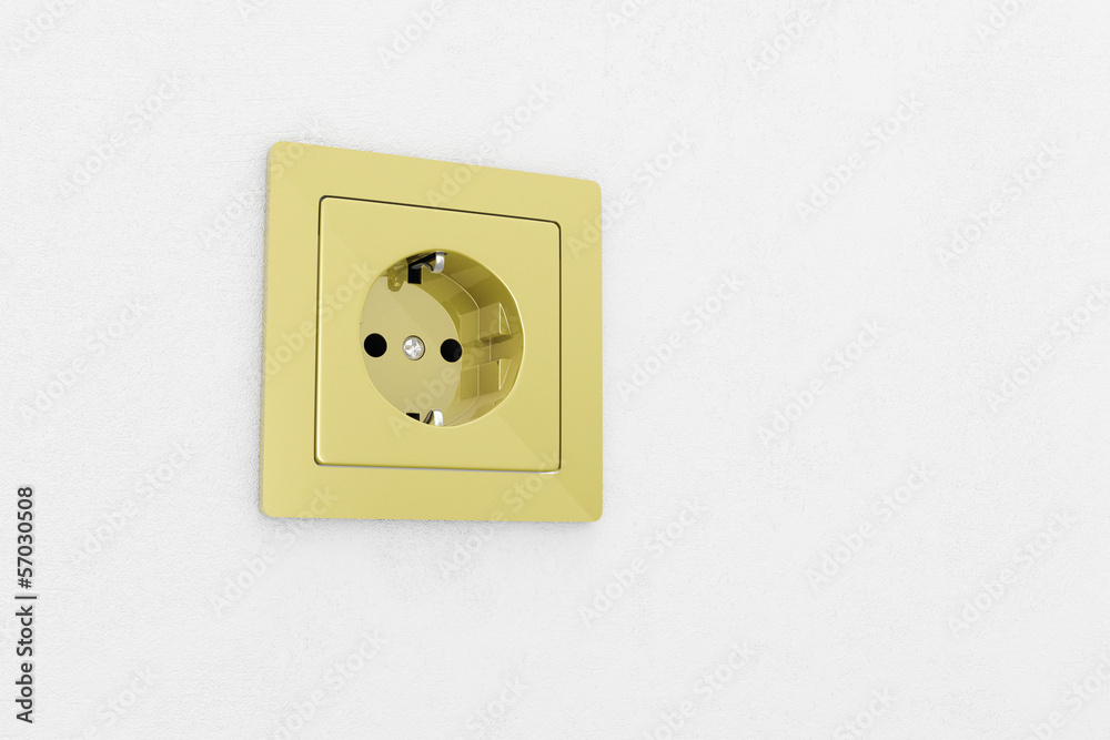 Golden power plug on white wall Golden power plug on white wall