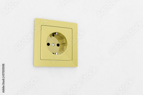 Golden power plug on white wall