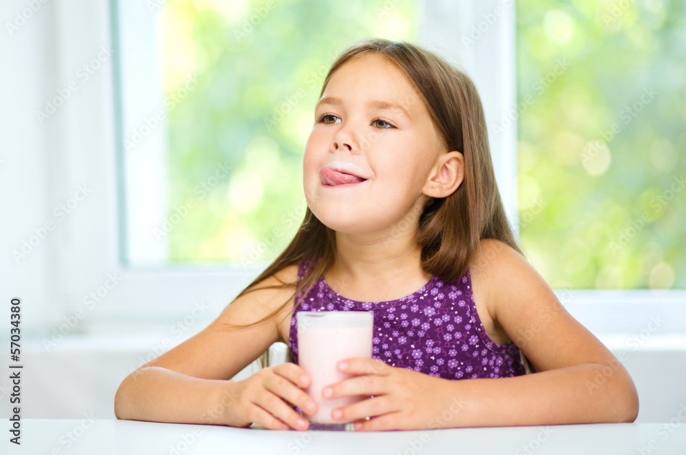 Cute little girl with a glass of milk