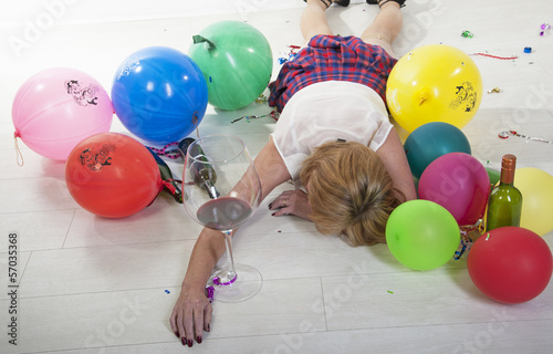 Party goer sleeping it off facedown on the floor photo