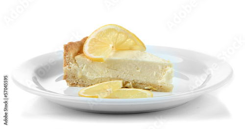 Slice of lemon cheesecake on plate, isolated on white