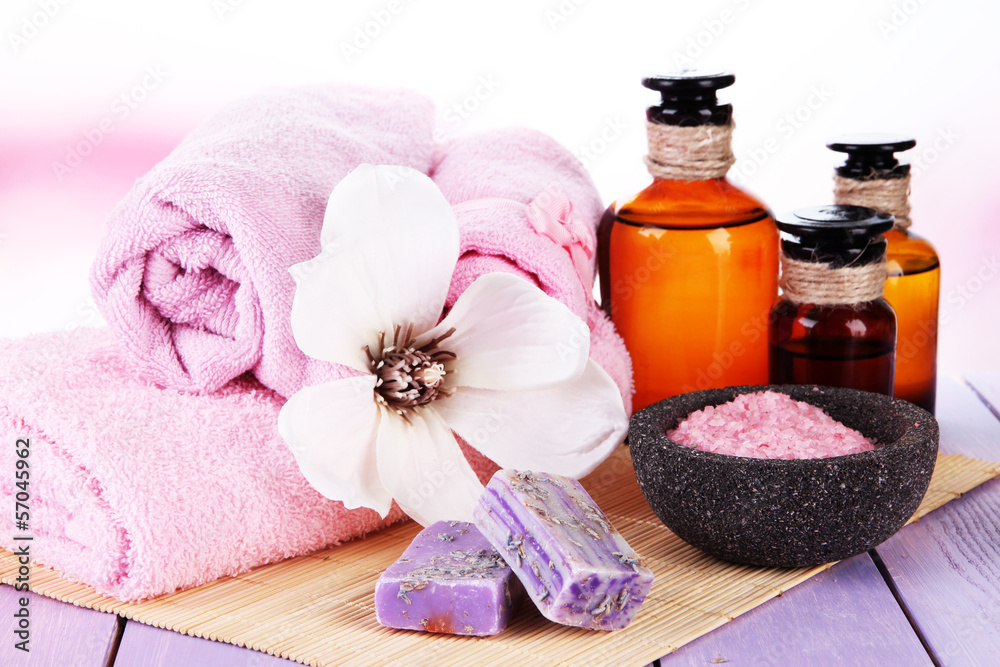 Beautiful spa setting with flower on wooden table close up Beautiful spa setting with flower on wooden table close up
