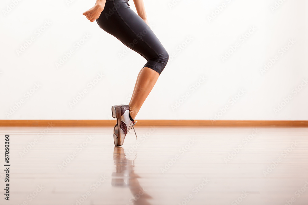 Fototapeta premium Female dancer tap dancing in the dance floor