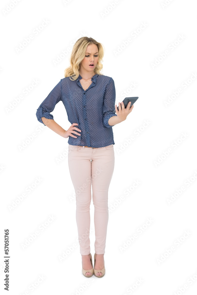 Shocked pretty blonde looking at calculator Shocked pretty blonde looking at calculator