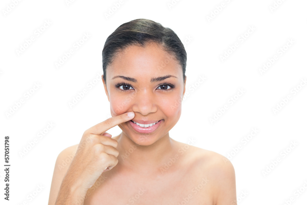 Natural young dark haired model pointing her nostril with her fi Natural young dark haired model pointing her nostril with her fi