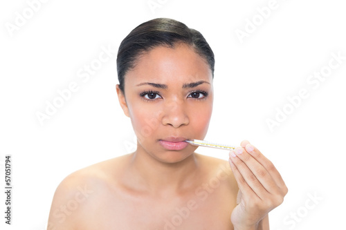 Sad young dark haired model using a thermometer