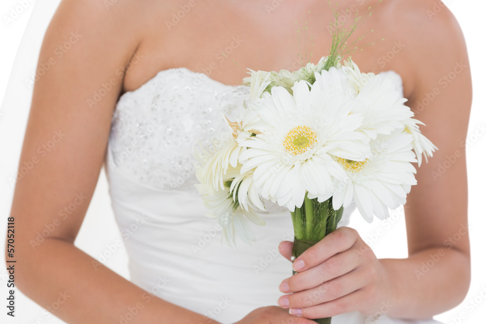Mid section of young bride holding a bouquet
