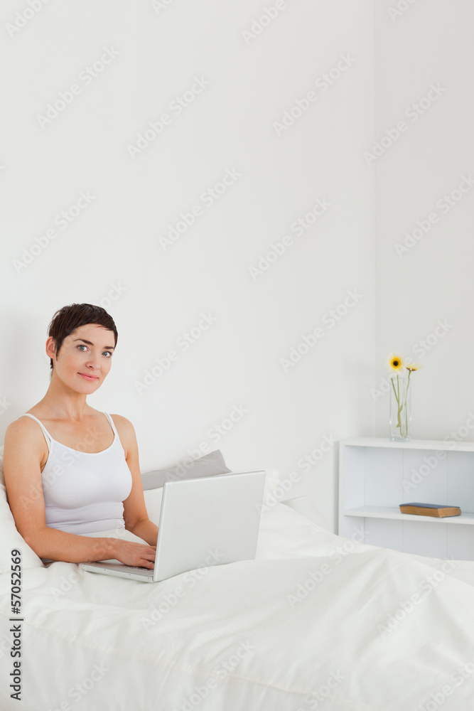 Portrait of a beautiful brunette using a laptop Portrait of a beautiful brunette using a laptop