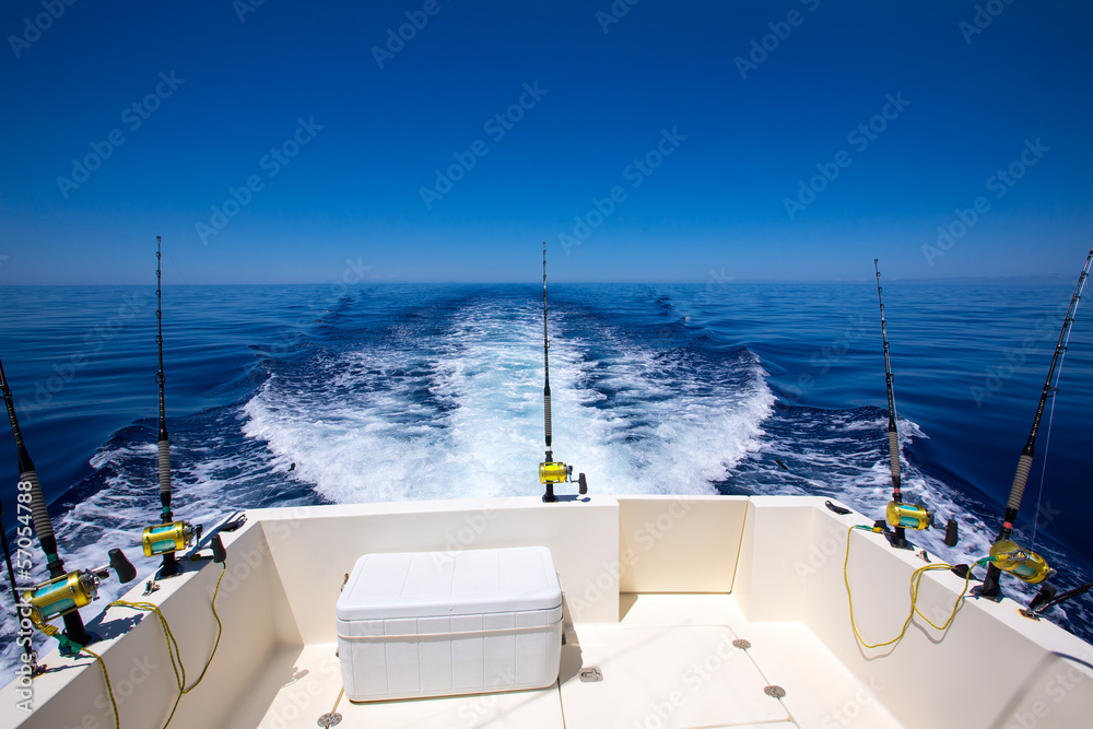 Fishing boat stern deck with trolling fishing rods and reels Stock