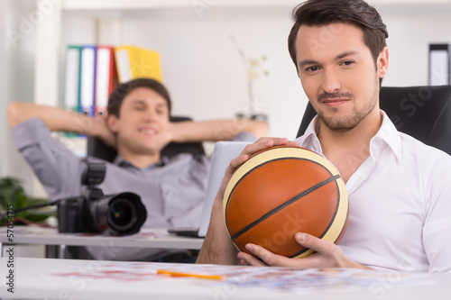Man with basketball ball on the foreground. photo