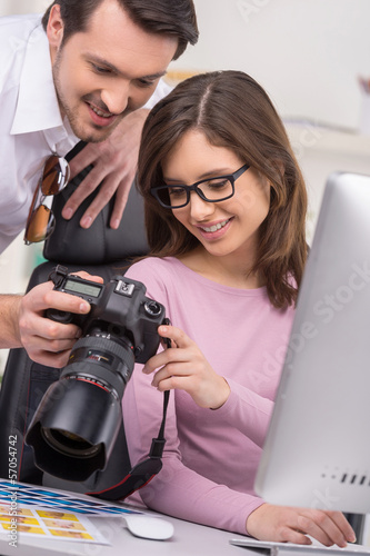 Man showing photo to a nice woman in glasses. photo