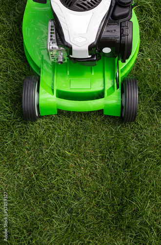 Green lawnmower on green lawn